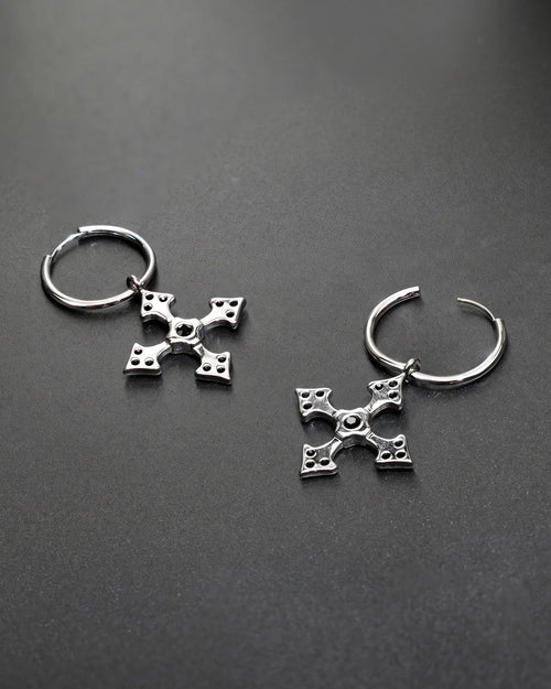 Silver hoop earrings with decorative elements on a dark gray background